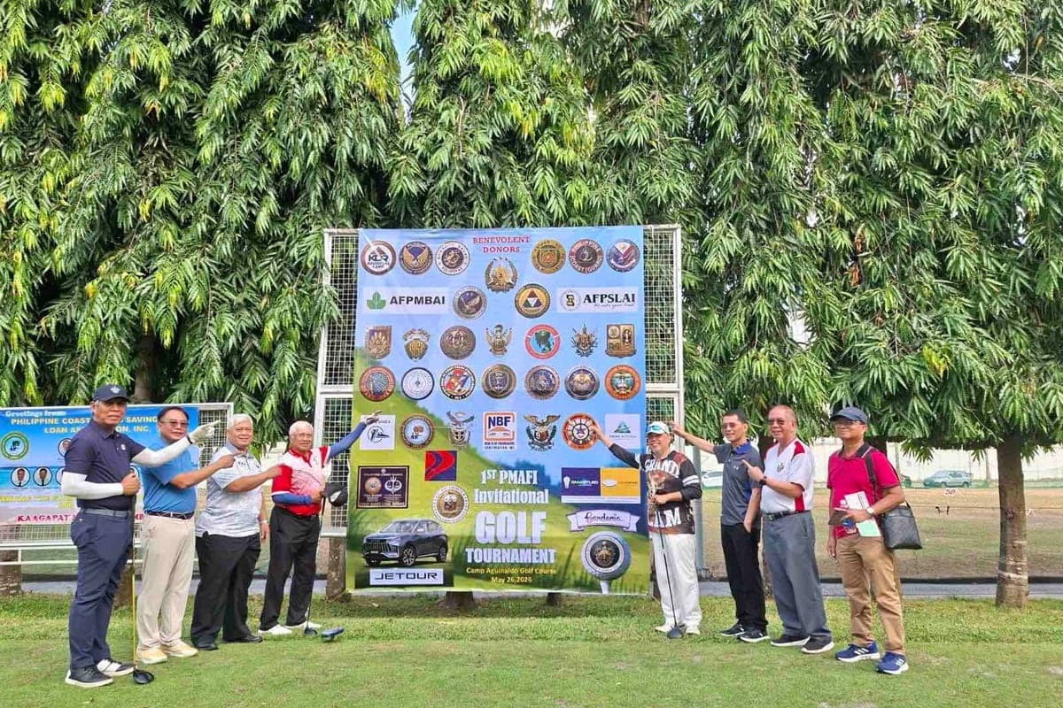 Players beside the tournament board at the Foundation's first invitational golf tournament, Camp Aguinaldo Golf Course.